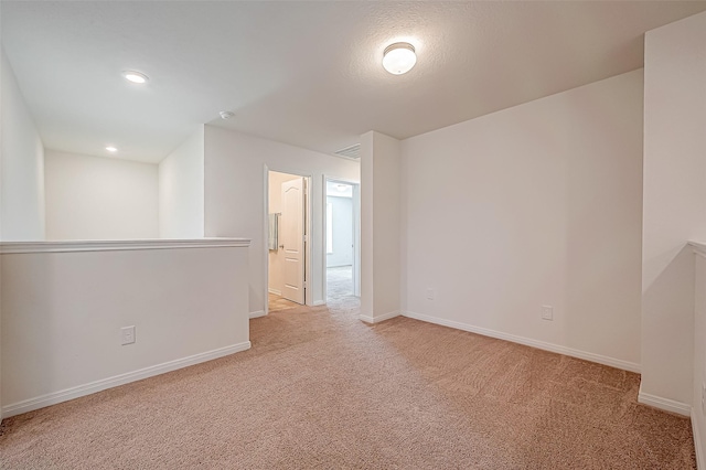 carpeted spare room with recessed lighting and baseboards