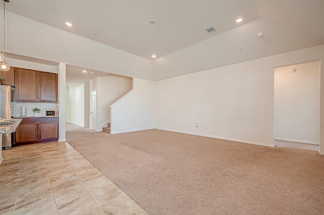 living room featuring stairs, recessed lighting, visible vents, and light colored carpet