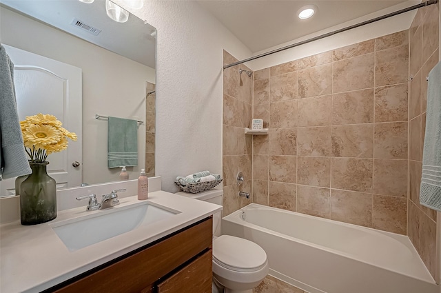 full bath featuring a textured wall, toilet, shower / bath combination, vanity, and visible vents