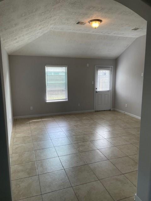 interior space with lofted ceiling and a textured ceiling