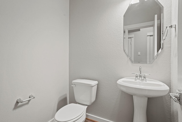 bathroom featuring toilet and sink