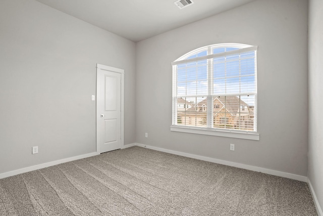 carpeted empty room with plenty of natural light