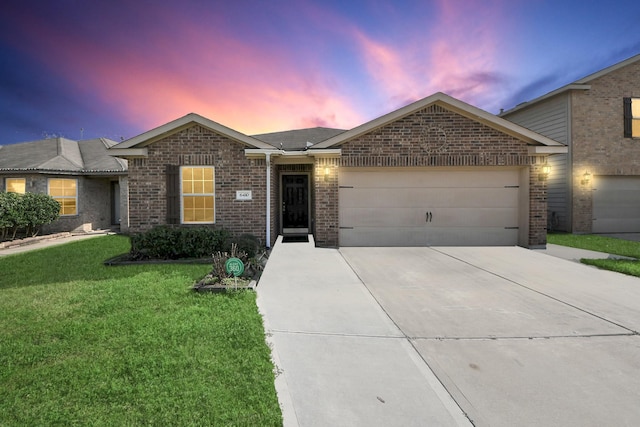 ranch-style home with a garage and a lawn