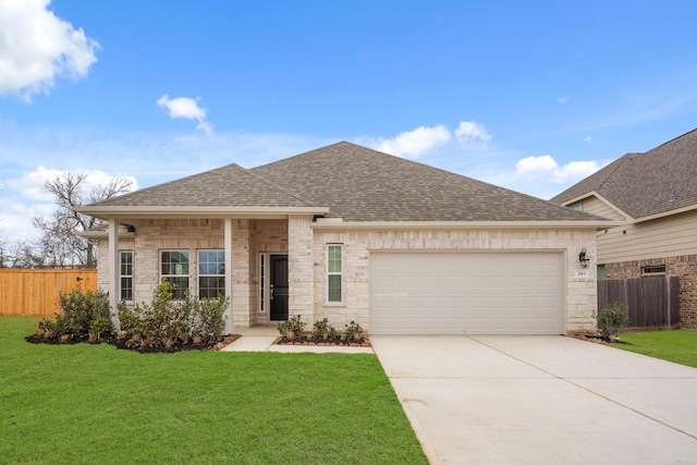 view of front of property featuring a garage and a front lawn