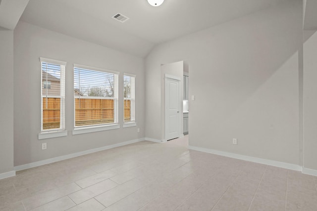 unfurnished room with lofted ceiling