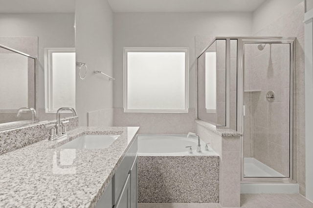 bathroom featuring tile patterned floors, vanity, and separate shower and tub