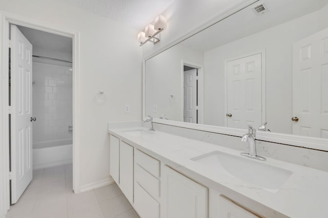 bathroom featuring tiled shower / bath combo, vanity, tile patterned floors, and a textured ceiling