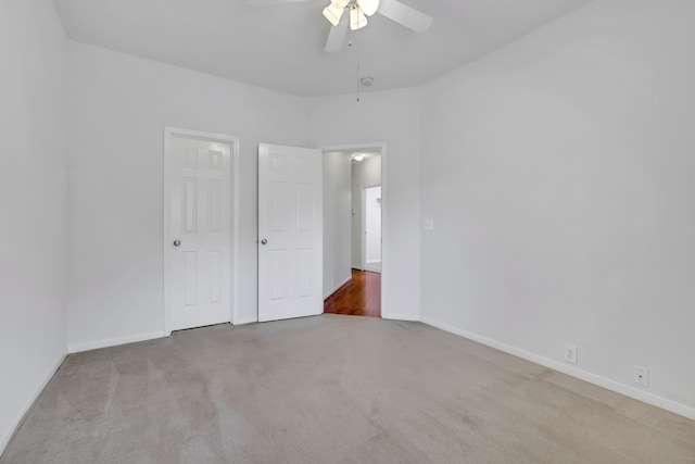 unfurnished bedroom featuring ceiling fan and light colored carpet