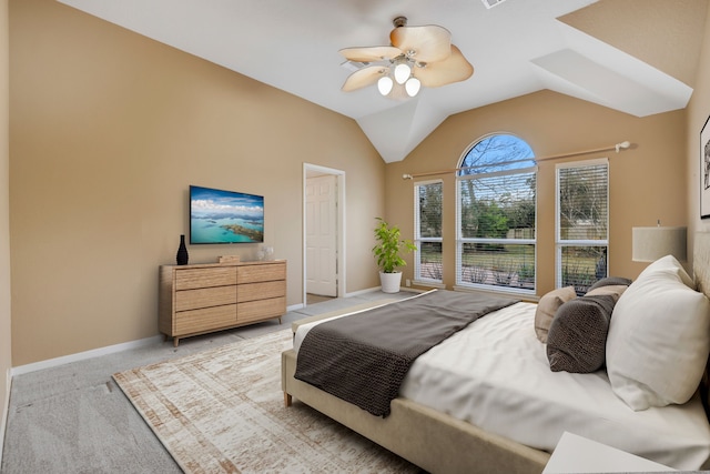 bedroom featuring ceiling fan, light colored carpet, and vaulted ceiling