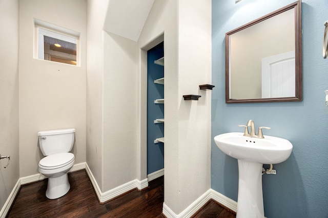 bathroom with hardwood / wood-style flooring, toilet, and sink