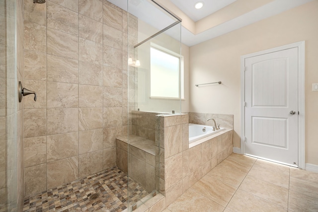 bathroom featuring plus walk in shower and tile patterned flooring