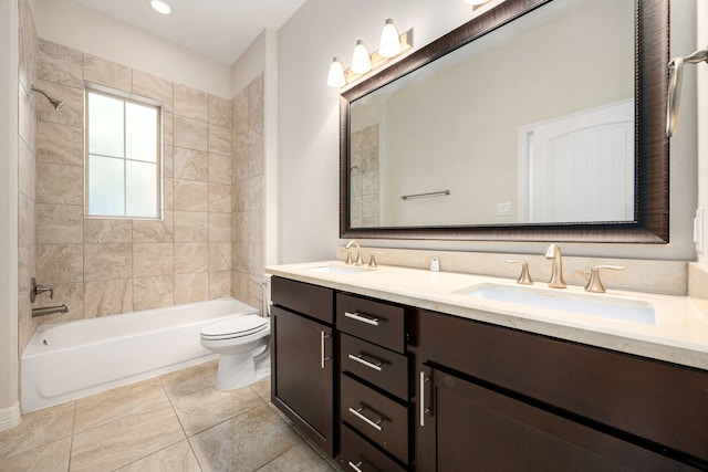 full bathroom with vanity, tile patterned flooring, toilet, and tiled shower / bath