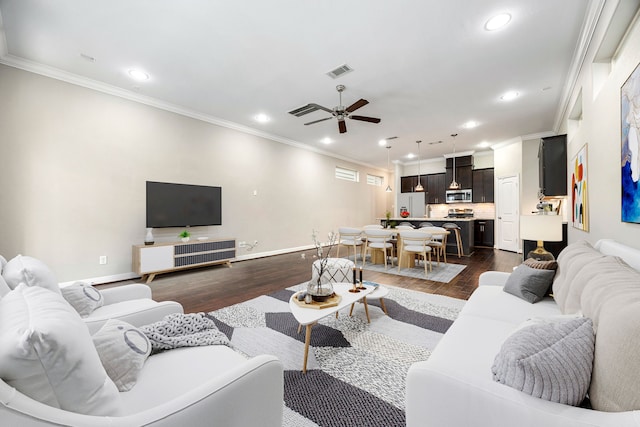 living room with ornamental molding, dark hardwood / wood-style floors, and ceiling fan