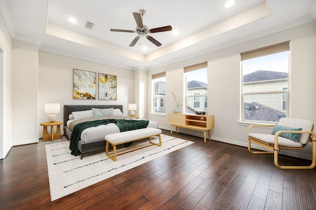 bedroom featuring crown molding, dark wood-type flooring, and a raised ceiling