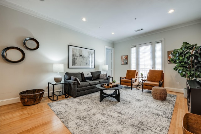 living room with crown molding and light hardwood / wood-style flooring