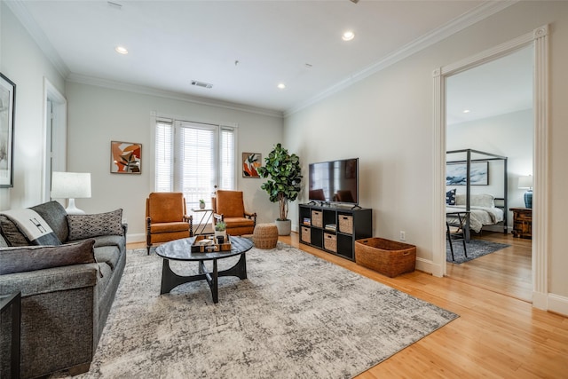 living room with ornamental molding and hardwood / wood-style floors