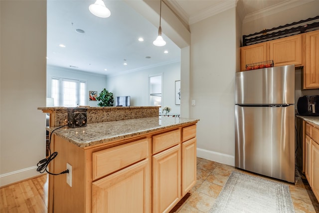 kitchen featuring stainless steel refrigerator, ornamental molding, and light brown cabinetry