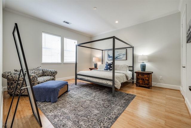 bedroom with hardwood / wood-style flooring and ornamental molding