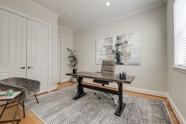 office with crown molding and light hardwood / wood-style floors