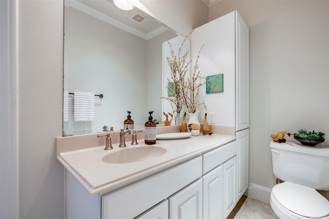 bathroom with ornamental molding, vanity, and toilet