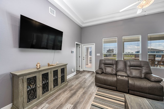 living room with hardwood / wood-style floors and ceiling fan