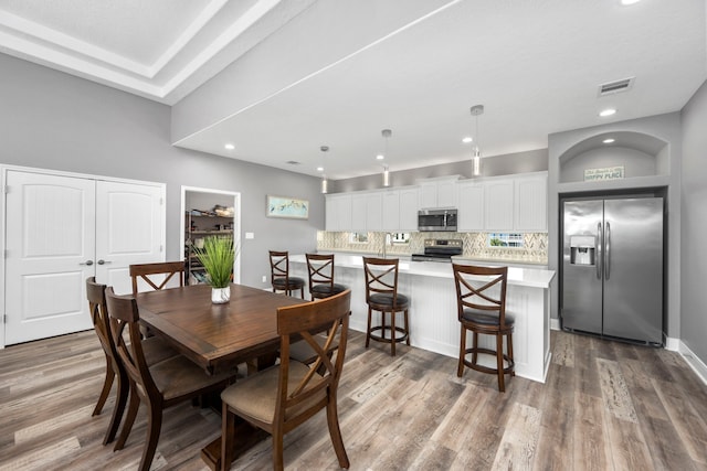 dining area with wood-type flooring