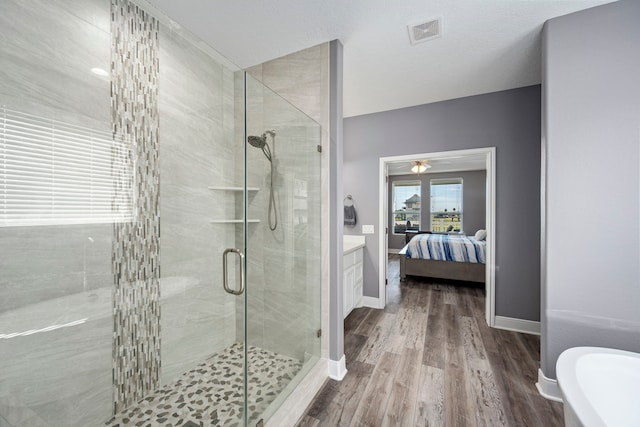 bathroom with vanity, separate shower and tub, and hardwood / wood-style floors