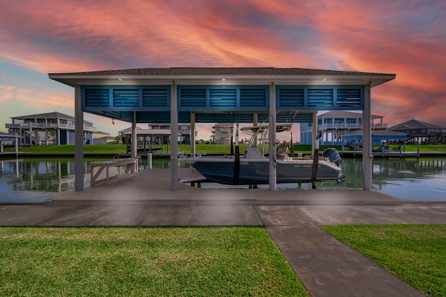 exterior space featuring a water view, a yard, and a boat dock