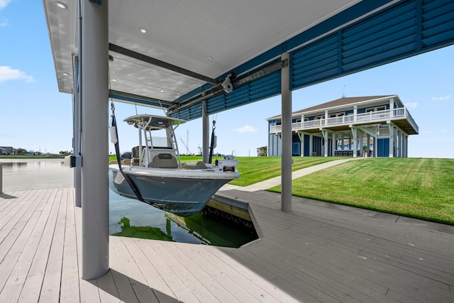 view of dock featuring a water view and a yard