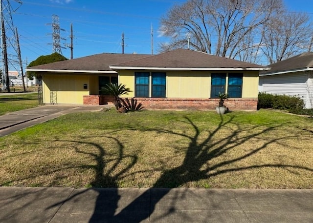 ranch-style home featuring a front yard