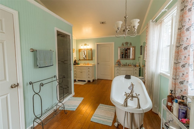 sitting room with an inviting chandelier, sink, ornamental molding, and light wood-type flooring