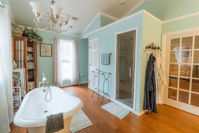 bathroom featuring lofted ceiling, crown molding, independent shower and bath, a notable chandelier, and hardwood / wood-style flooring