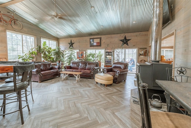 living room with light parquet flooring, vaulted ceiling, wood ceiling, and wood walls