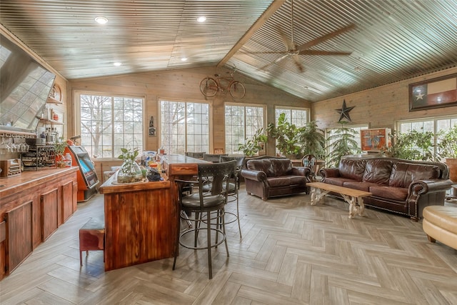 sunroom with ceiling fan, vaulted ceiling, and a healthy amount of sunlight