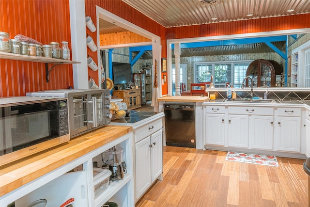 kitchen with white cabinetry, sink, light hardwood / wood-style floors, and dishwasher