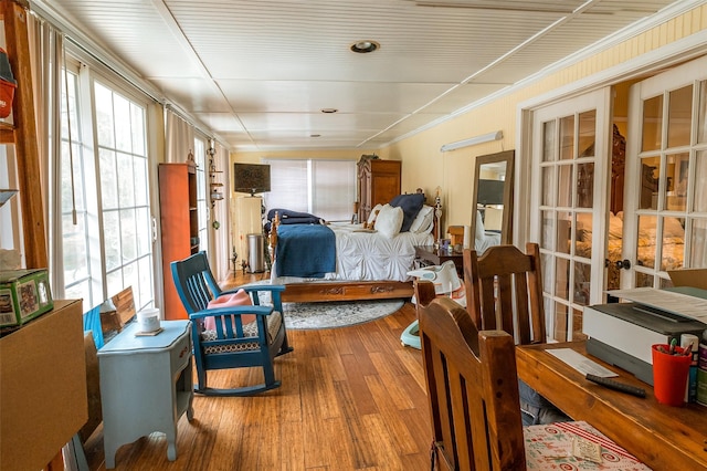 bedroom featuring crown molding and wood-type flooring