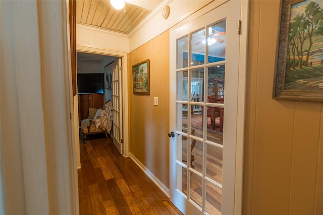 hallway featuring ornamental molding and dark hardwood / wood-style flooring