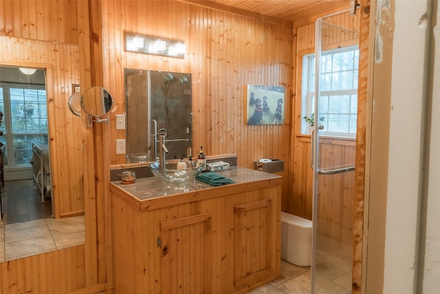 bathroom with vanity and wooden walls