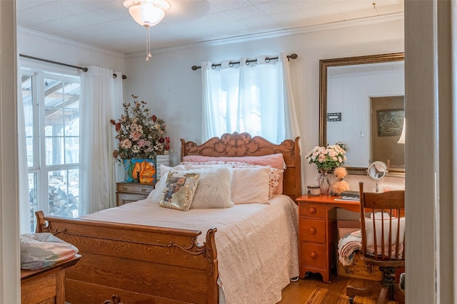 bedroom featuring hardwood / wood-style floors and crown molding