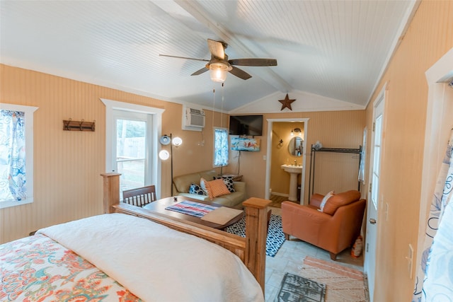 bedroom with connected bathroom, sink, vaulted ceiling with beams, a wall mounted AC, and ceiling fan