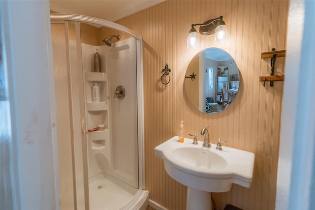 bathroom featuring sink and a shower with door