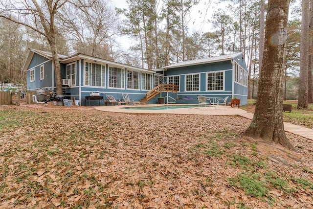 back of house with a sunroom and a patio