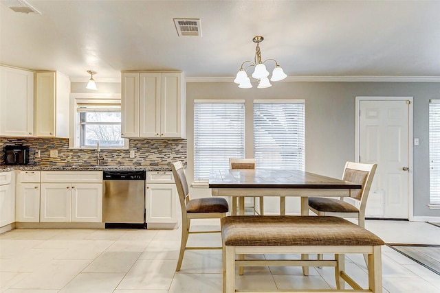 kitchen with pendant lighting, ornamental molding, dishwasher, and tasteful backsplash