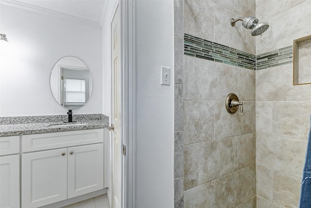 bathroom with vanity and tiled shower