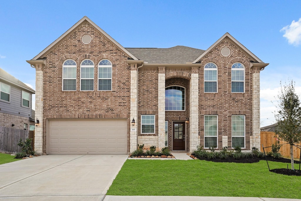 view of front of home featuring a garage and a front lawn