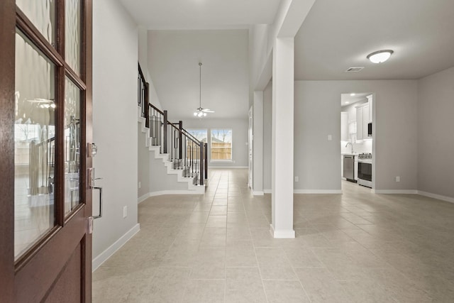 entryway featuring sink, light tile patterned floors, and ceiling fan