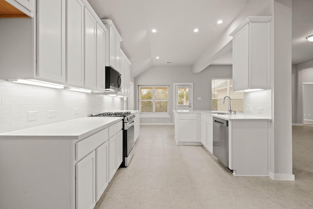 kitchen featuring tasteful backsplash, white cabinetry, sink, light tile patterned floors, and stainless steel appliances