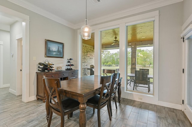 dining space featuring crown molding and ceiling fan