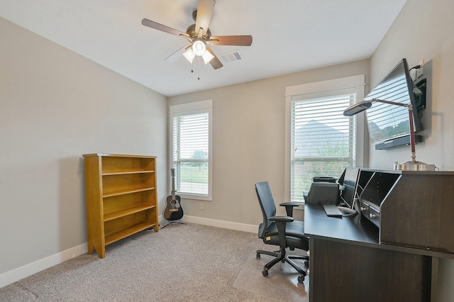 carpeted home office featuring ceiling fan