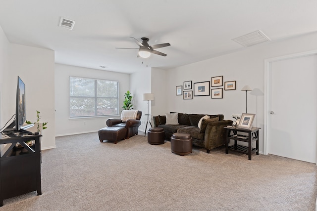 living room featuring ceiling fan and carpet